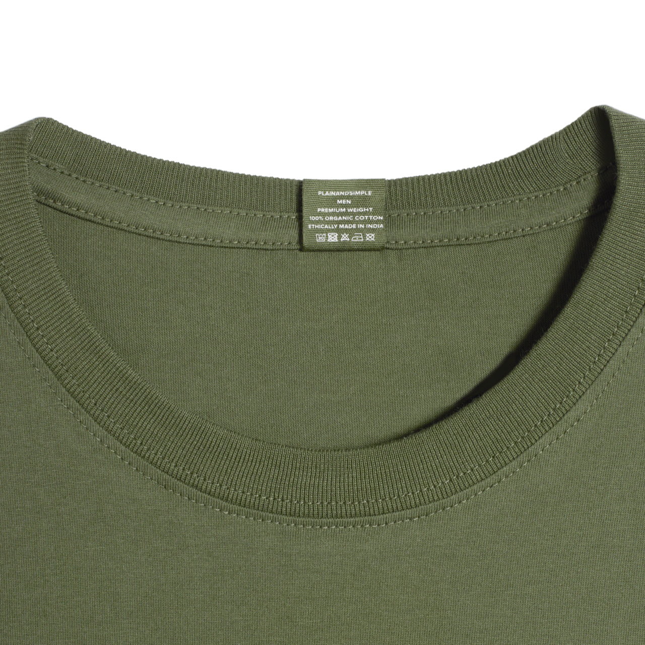 A close up of a neck label in a men's khaki green short sleeve crew neck organic cotton t shirt.