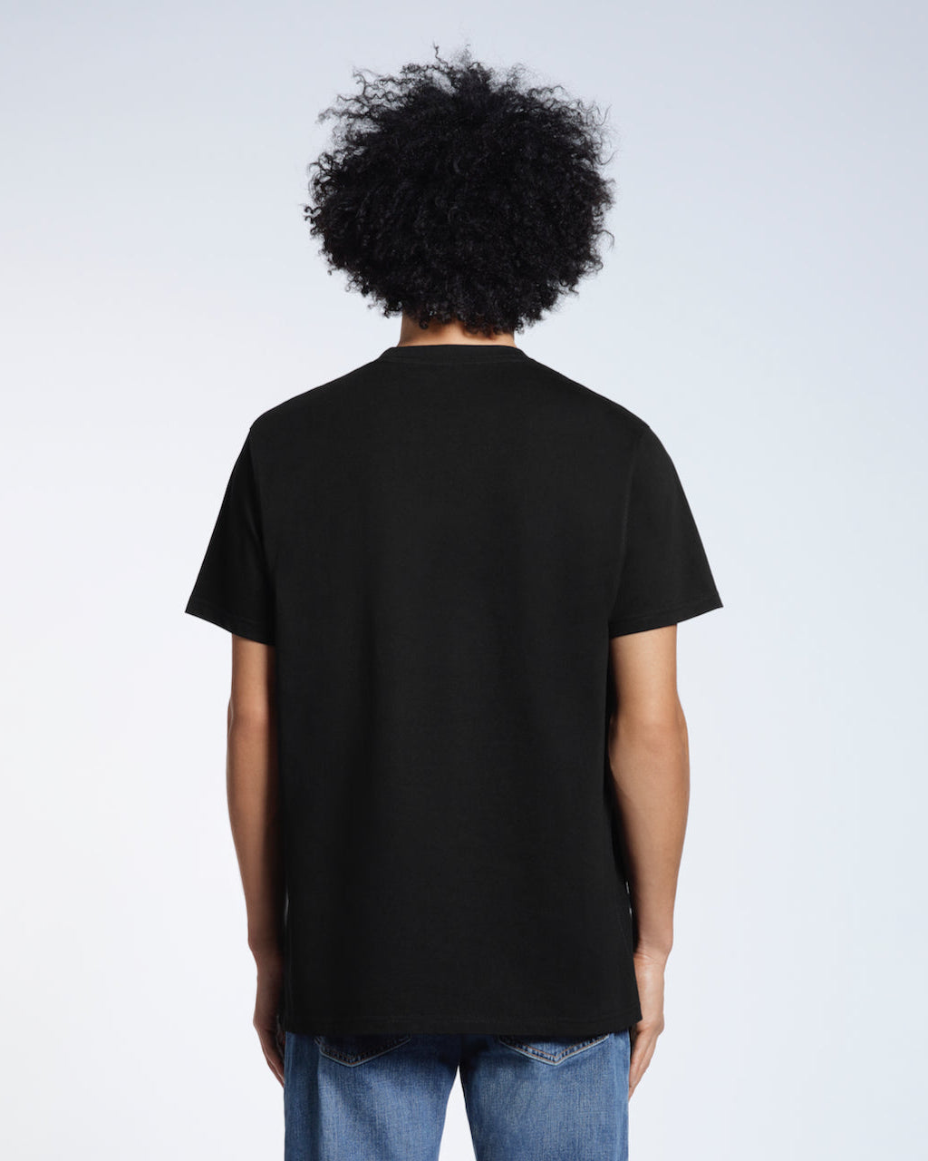A man facing away from the camera, modelling a plain navy short sleeve organic cotton t shirt.