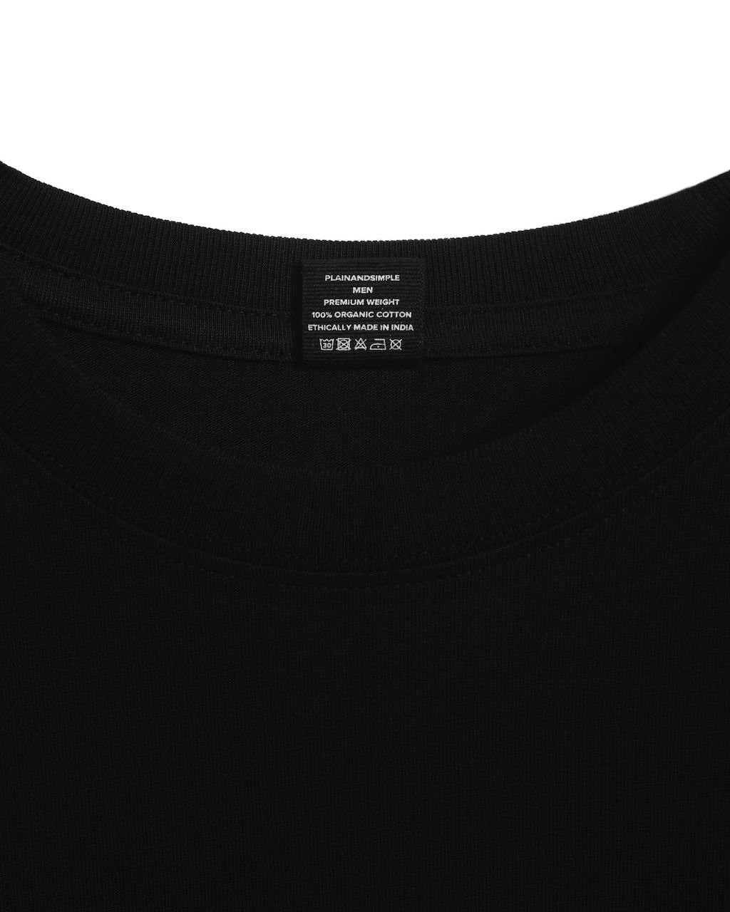 A close up of an neck label in a men's black short sleeve crew neck organic cotton t shirt.