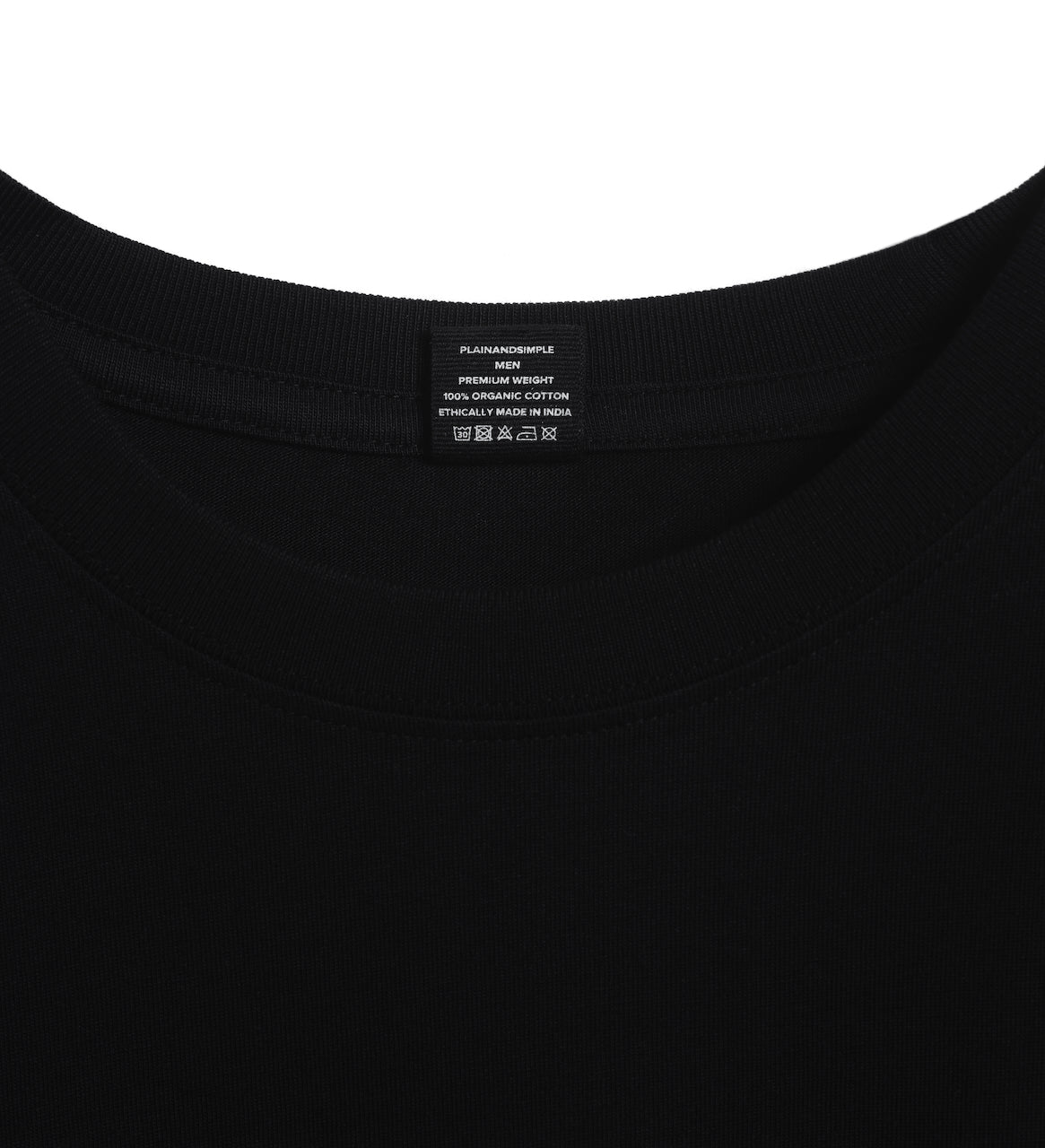 A close up of an neck label in a men's black short sleeve crew neck organic cotton t shirt.
