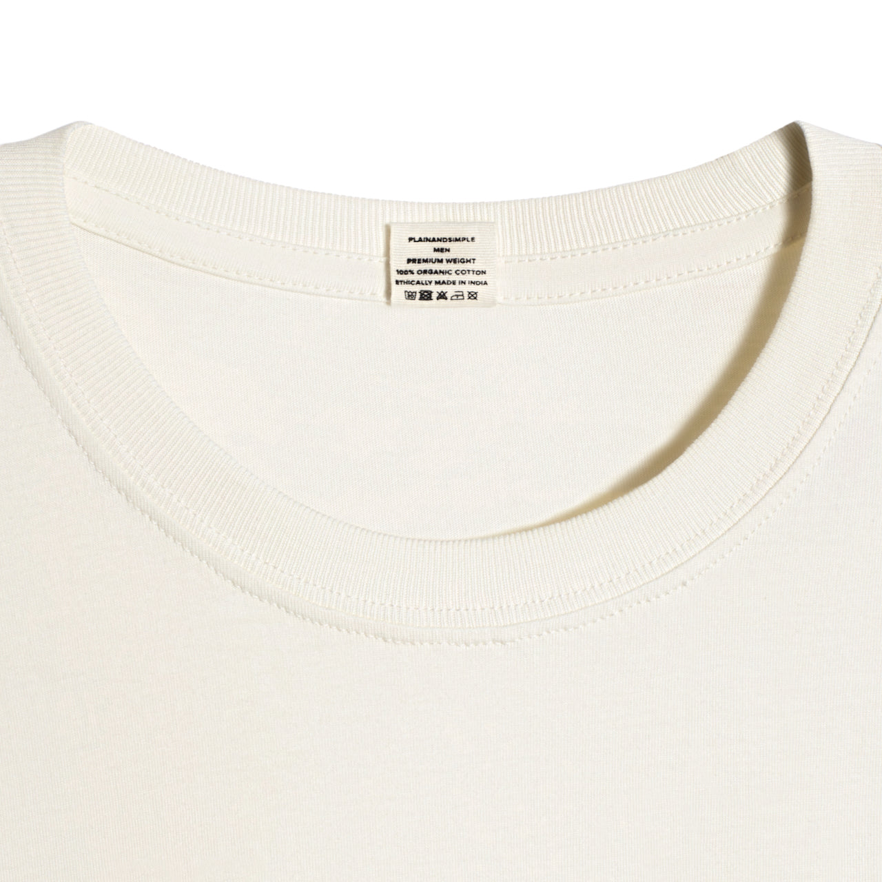 A close up of a neck label in a men's ecru short sleeve crew neck organic cotton t shirt.