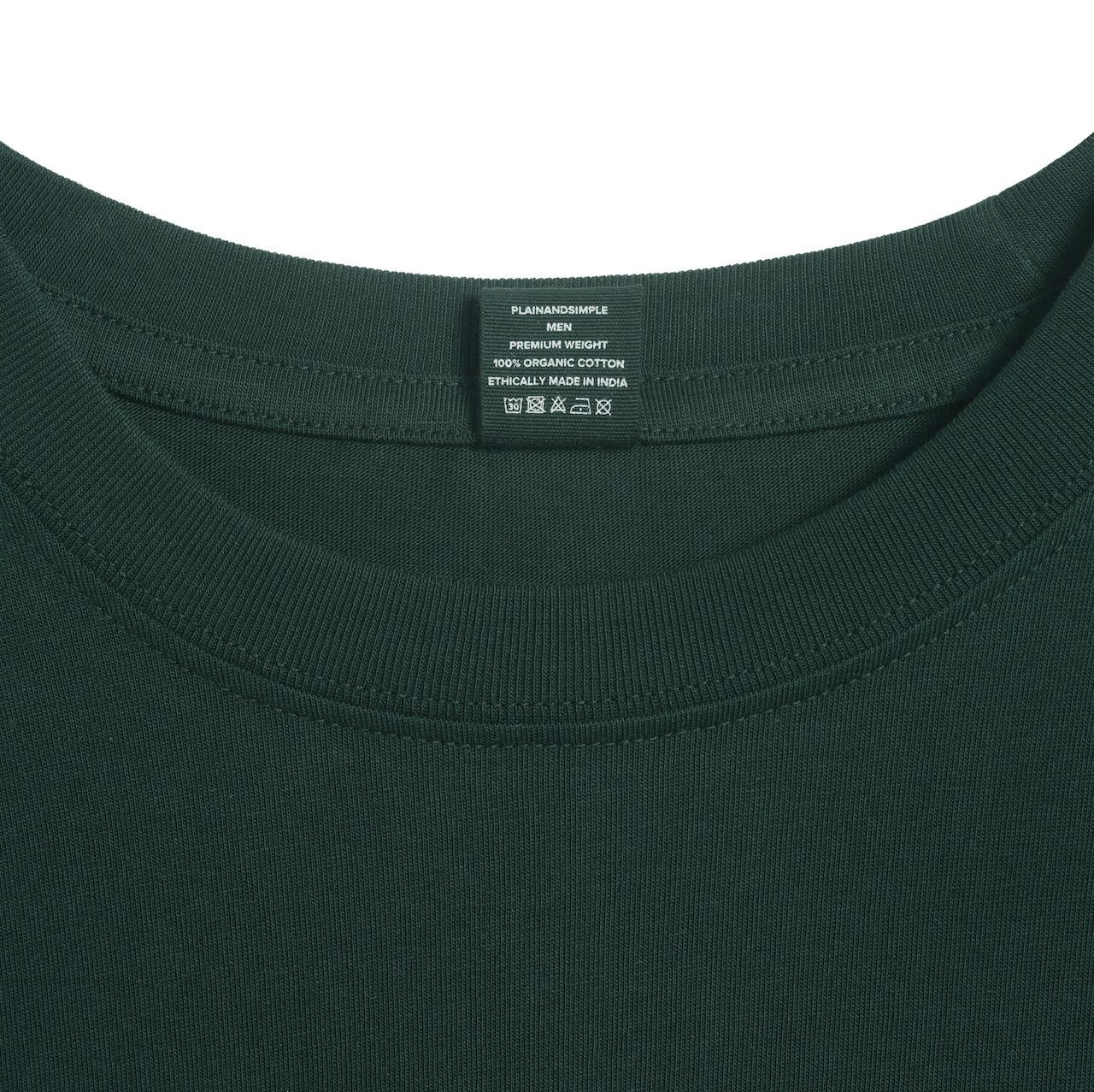 A close up of an neck label in a men's green short sleeve crew neck organic cotton t shirt.