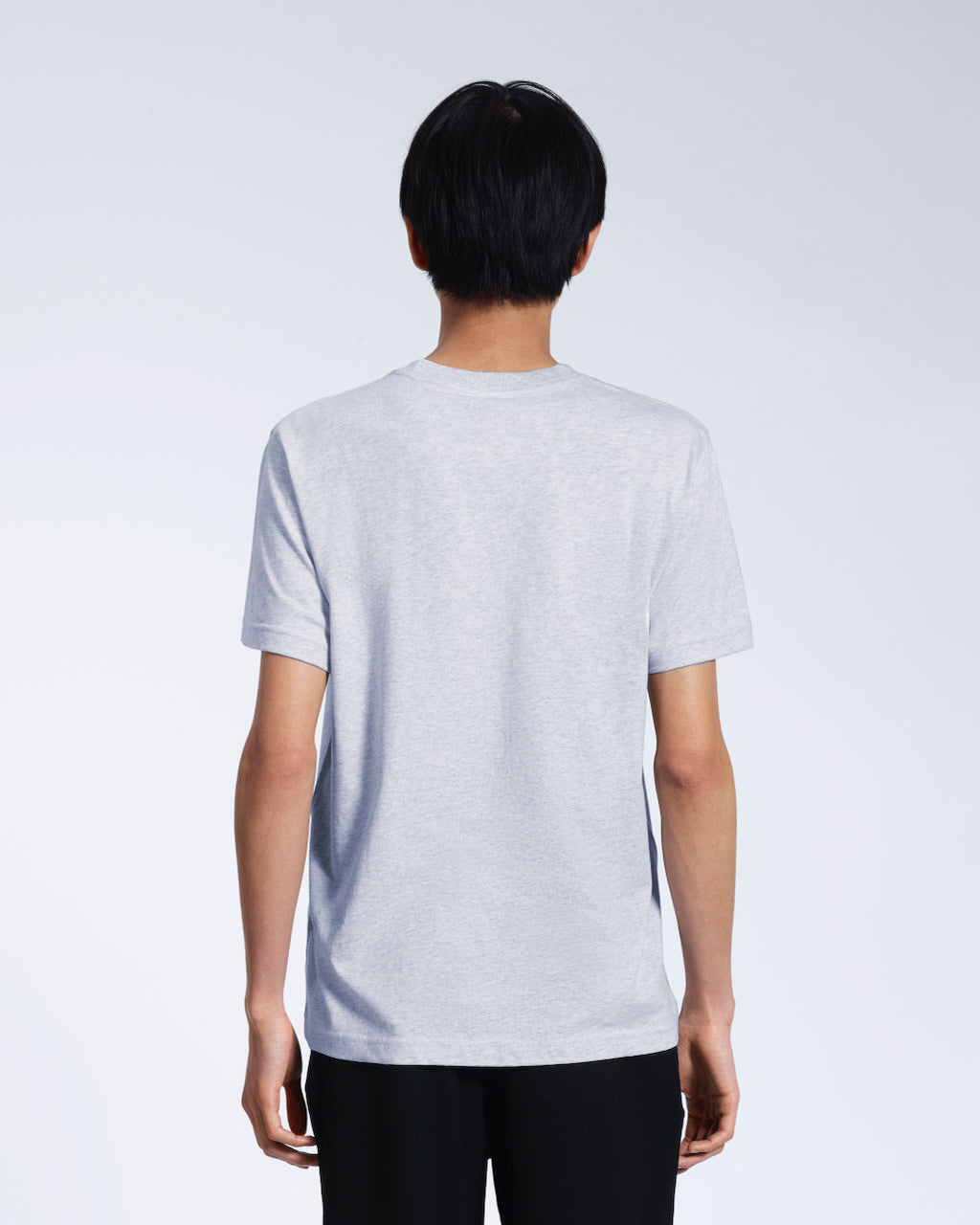 A man facing away from the camera, modelling a plain grey short sleeve organic cotton t-shirt.