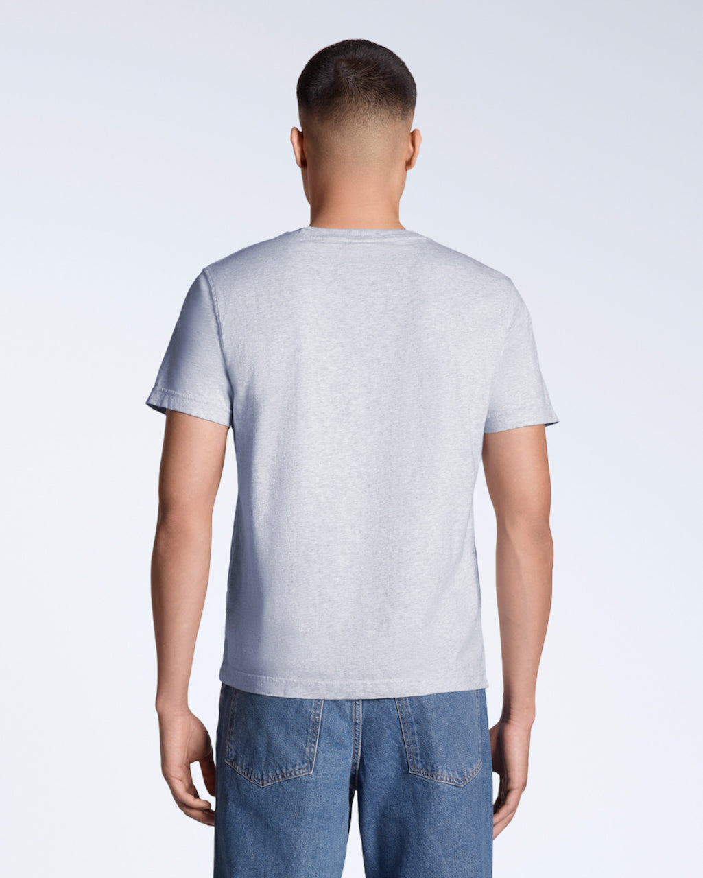 A man facing away from the camera, modelling a plain grey short sleeve organic cotton t shirt.