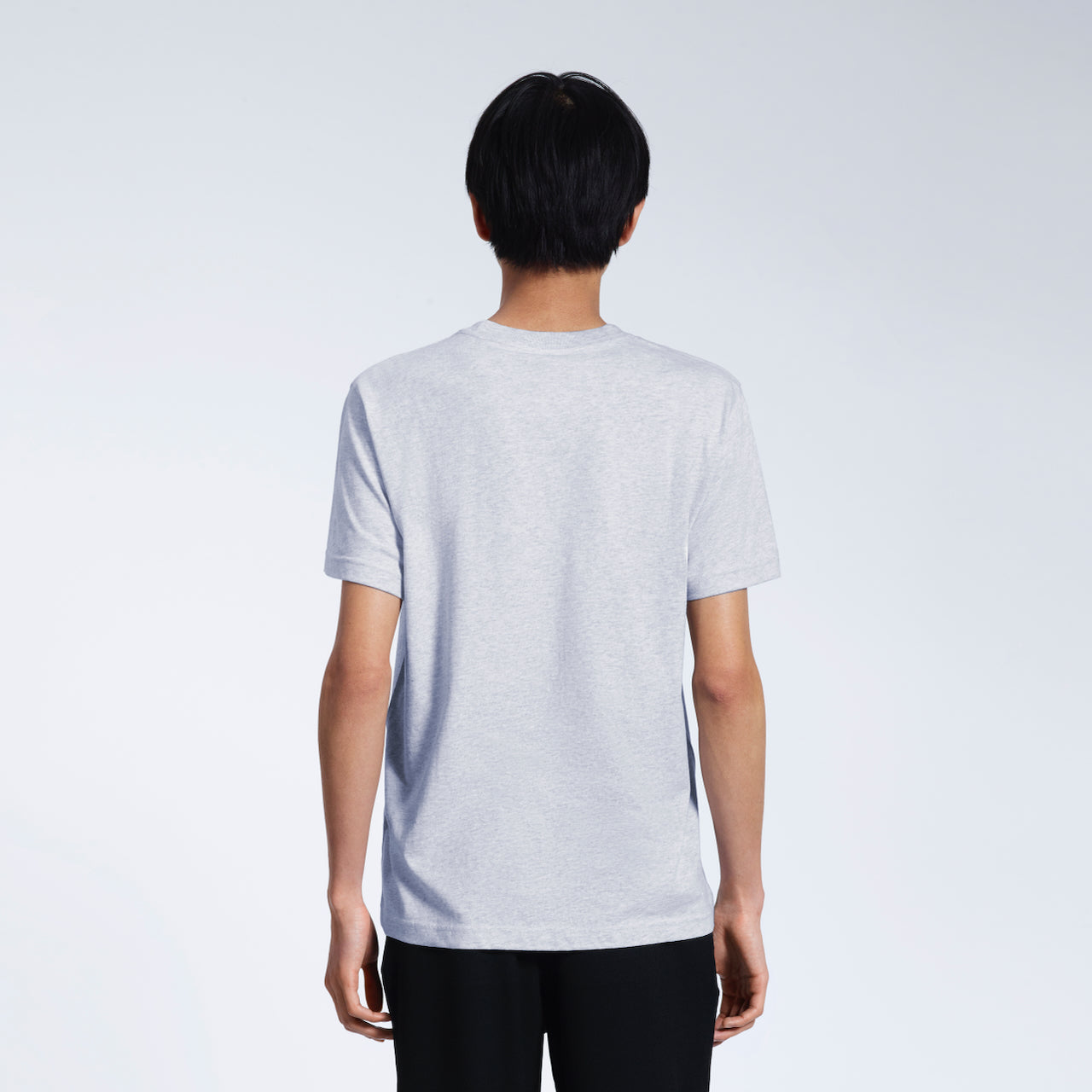 A man facing away from the camera, modelling a plain grey short sleeve organic cotton t-shirt.