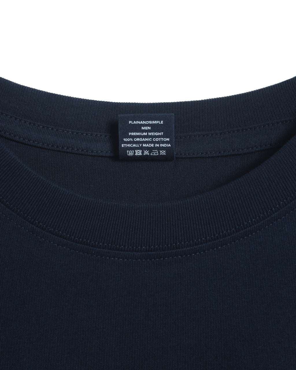 A close up of an neck label in a men's navy short sleeve crew neck organic cotton t shirt.