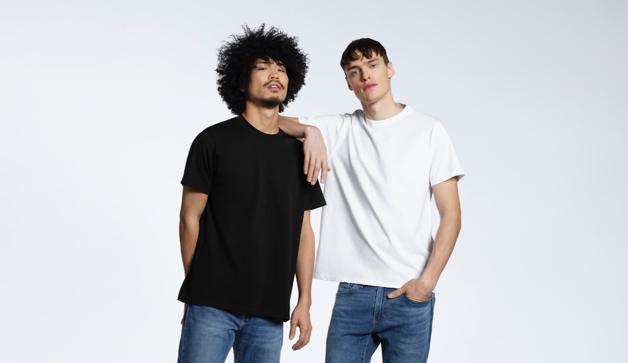 Two men looking into the camera, modelling plain black and white short sleeve organic cotton t shirts.