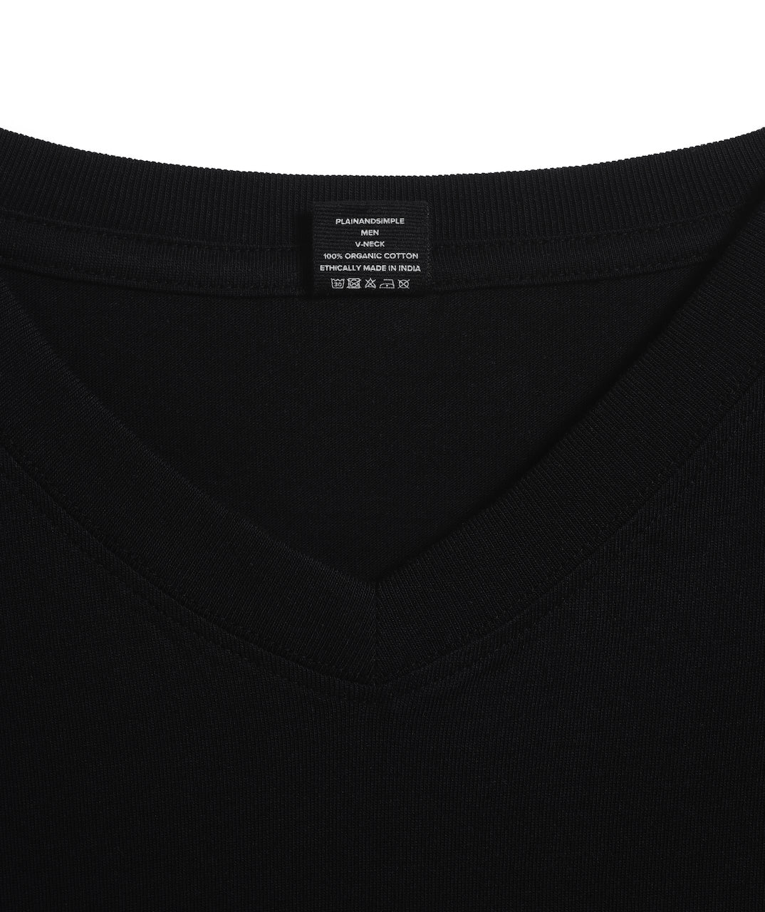 A close up of an neck label in a men's black short sleeve v neck organic cotton t shirt.