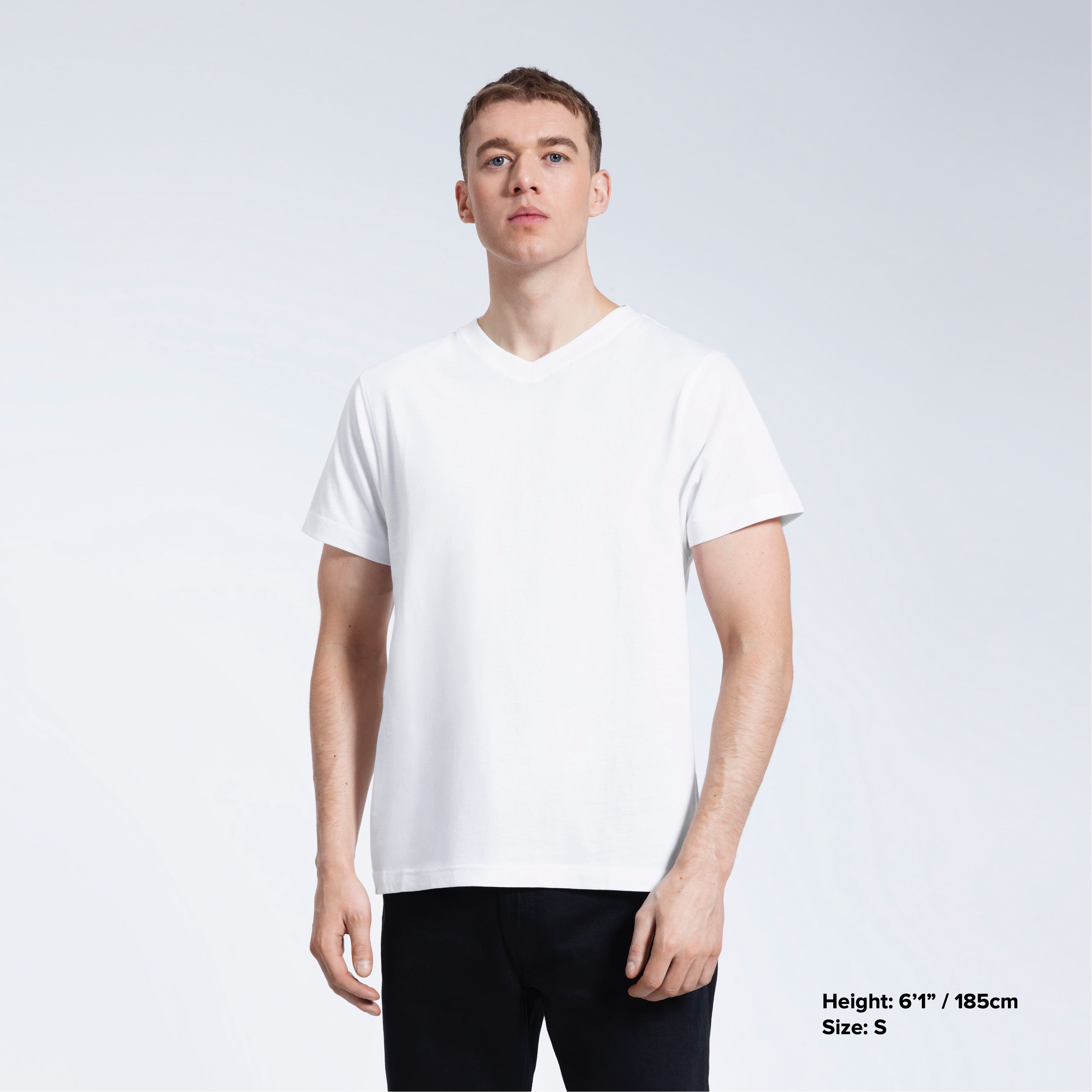 A man facing front on with his arms by his sides, modelling a plain white organic cotton v neck t shirt.