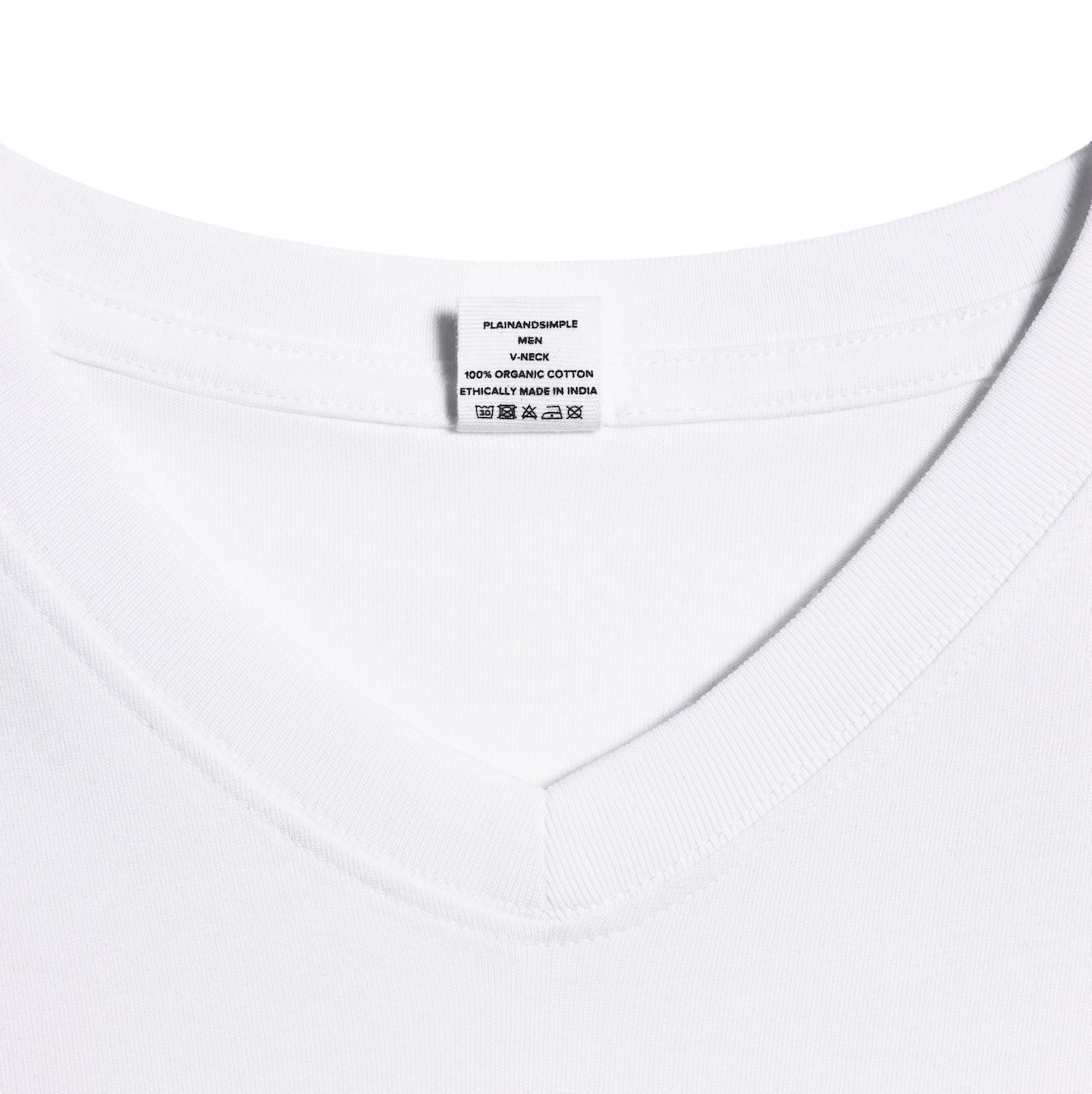 A close up of an neck label in a men's white short sleeve v neck organic cotton t shirt.