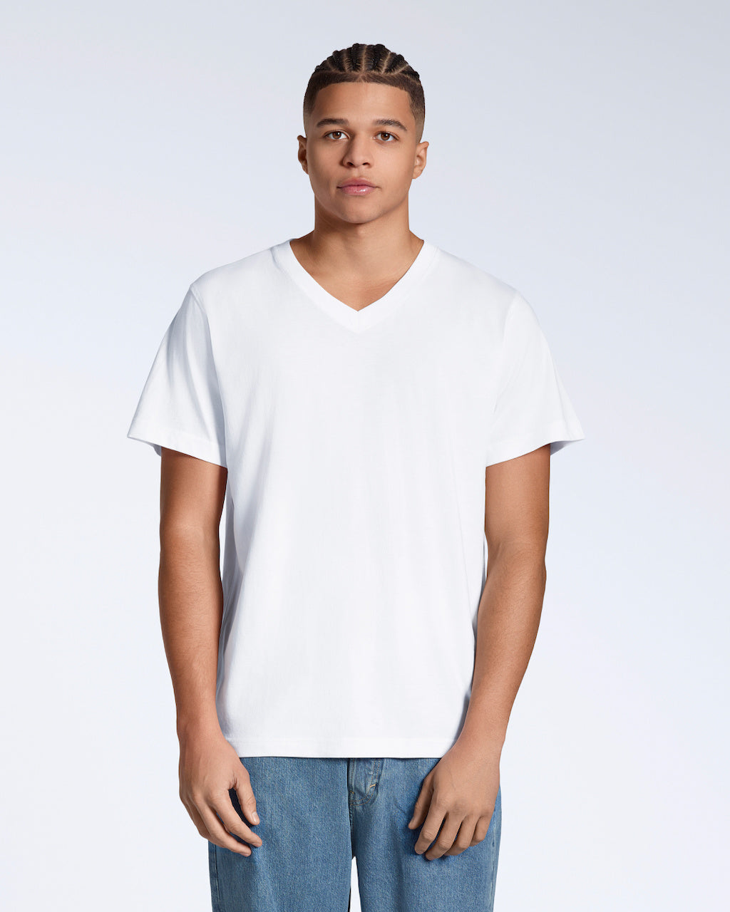 A man facing front on, looking into the camera with his arms by his side, modelling a plain white, organic cotton v neck t shirt.