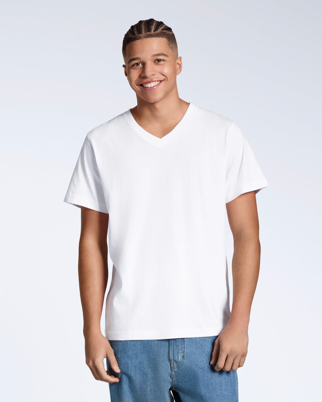 A man smiling into the camera, modelling a plain white, organic cotton v neck t shirt.