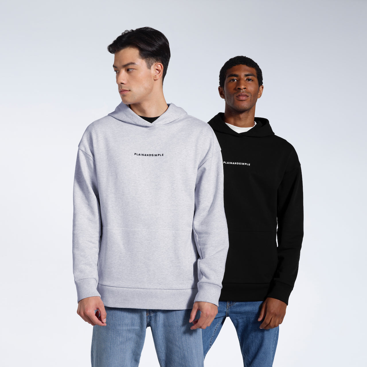 Two men modelling branded black and grey, heavyweight, organic cotton hoodies.