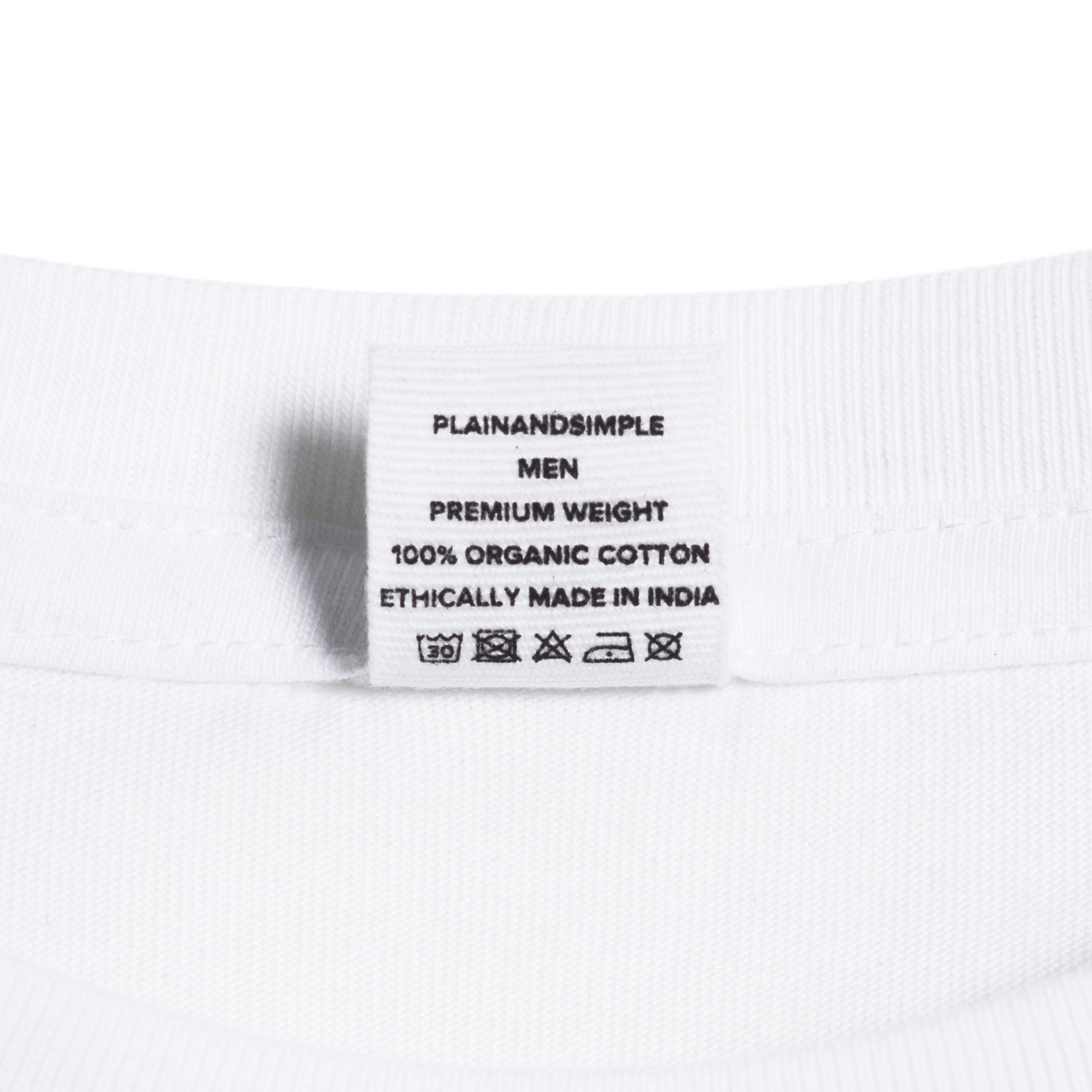 A close up of an neck label in a men's white short sleeve crew neck organic cotton t shirt.