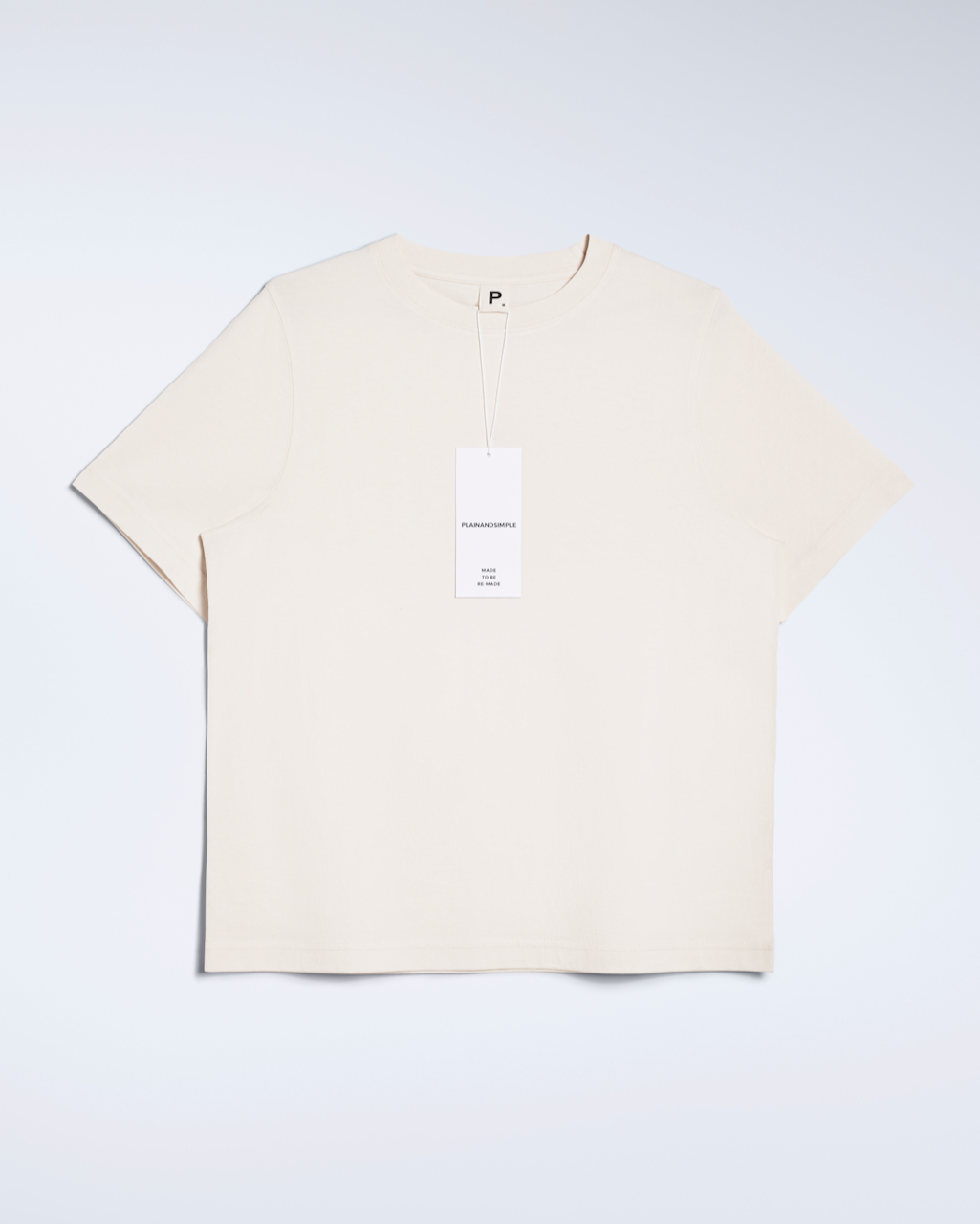 A flatlay of a natural coloured, crew neck, organic cotton t shirt.