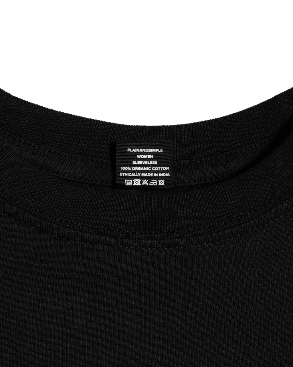 A close up of a neck label in a women's black sleeveless organic cotton crew neck tank top.