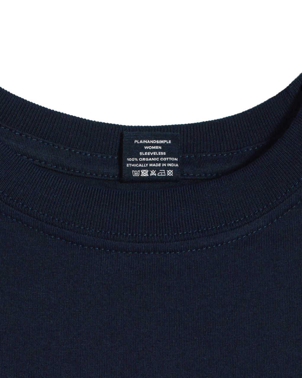 A close up of a neck label in a women's navy sleeveless organic cotton crew neck tank top.
