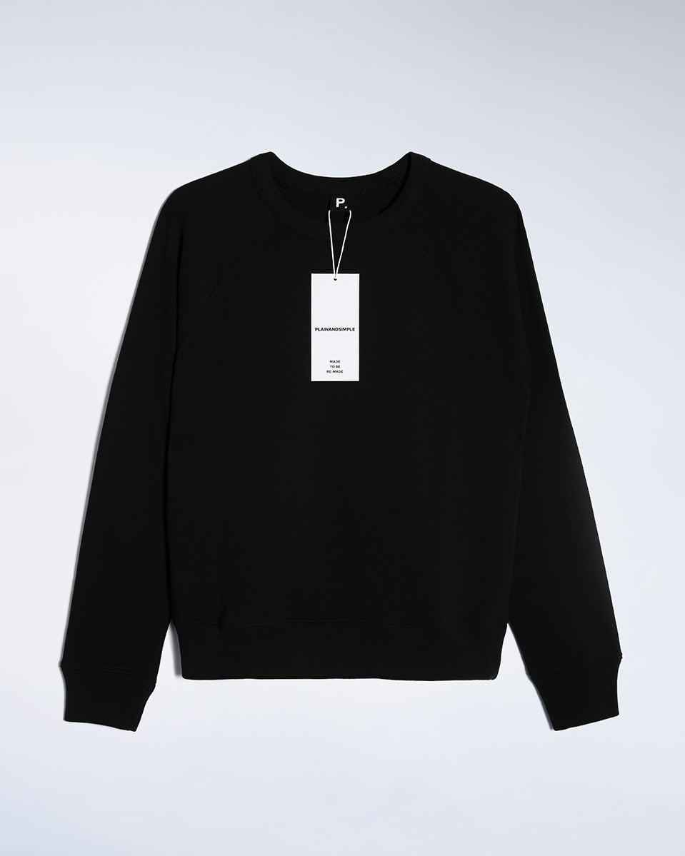 A flatlay of a women's plain black organic cotton sweatshirt.
