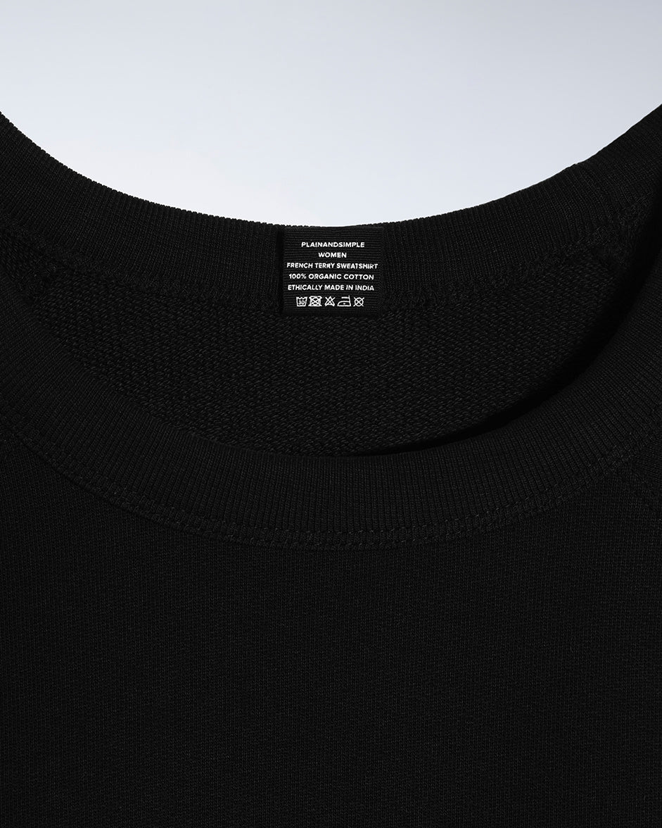 A close up of an neck label in a women's black organic cotton sweatshirt.