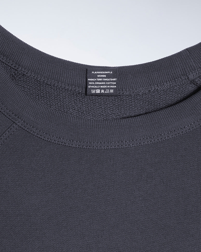 A close up of an neck label in a women's dark grey organic cotton sweatshirt.