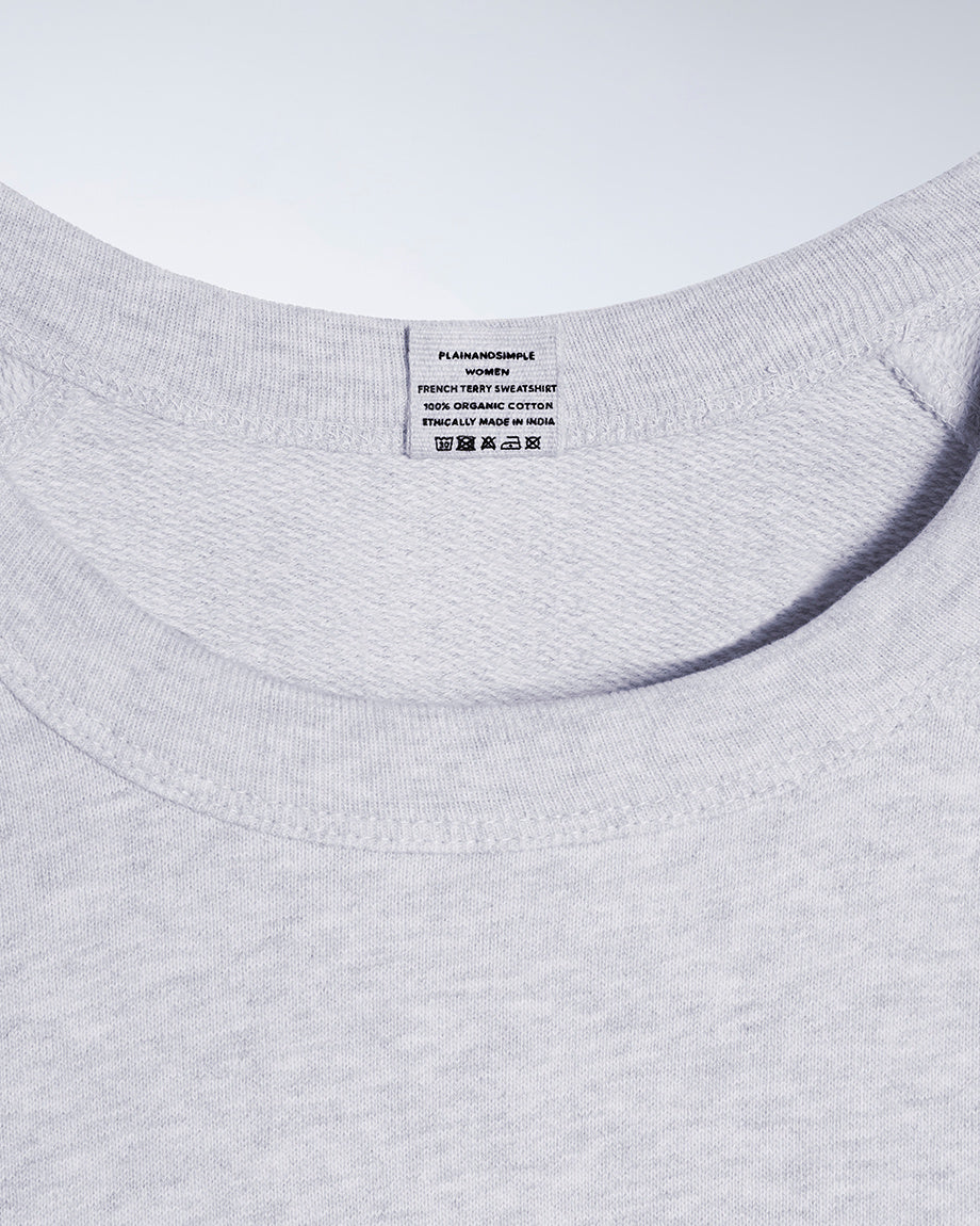 A close up of an neck label in a women's grey organic cotton sweatshirt.
