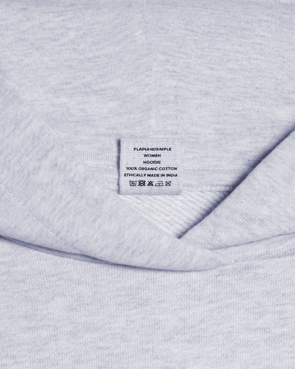 A close up of a neck label in a women's grey heavyweight organic cotton hoodie.