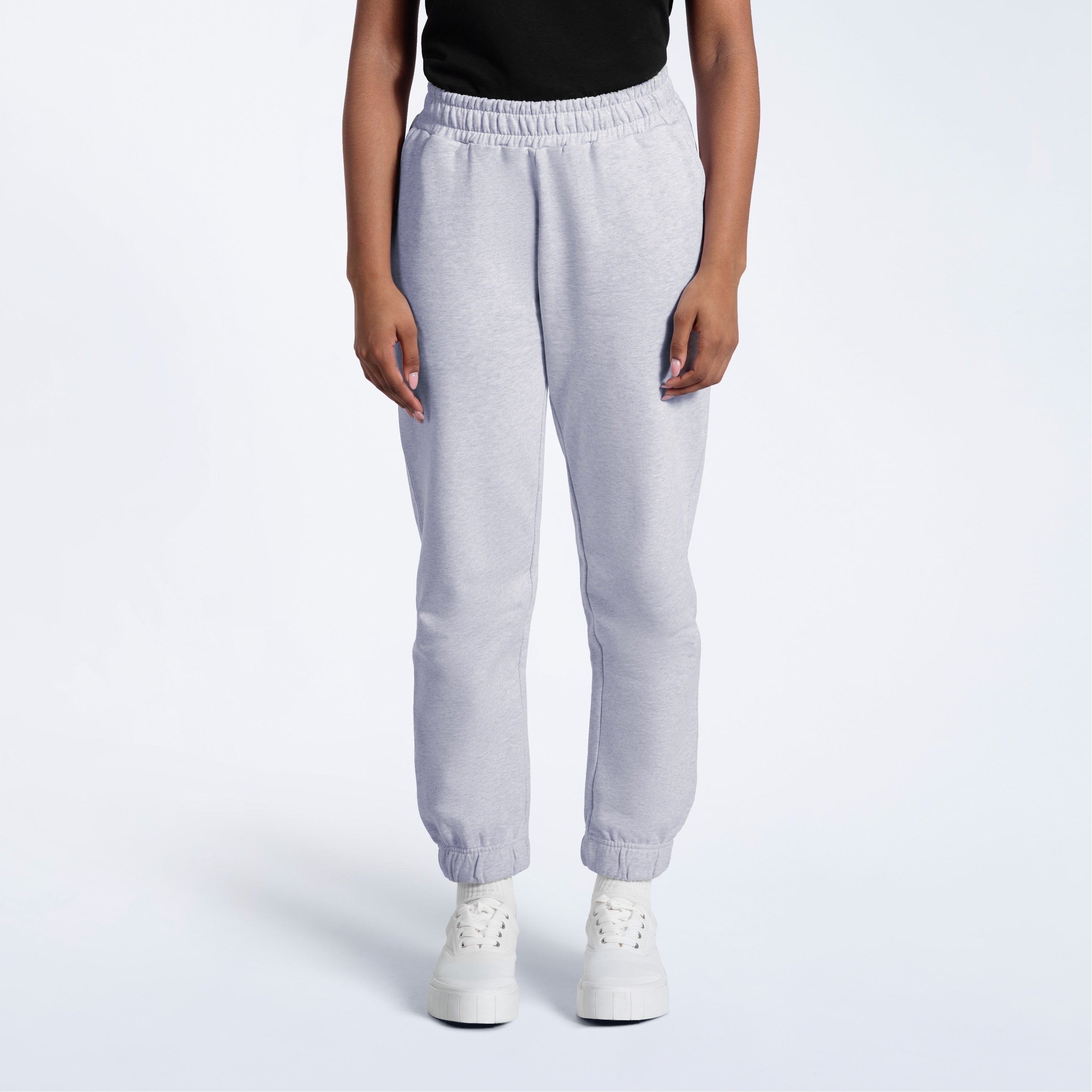 A person with their arms by their sides, modelling a pair of women's grey heavyweight organic cotton joggers.
