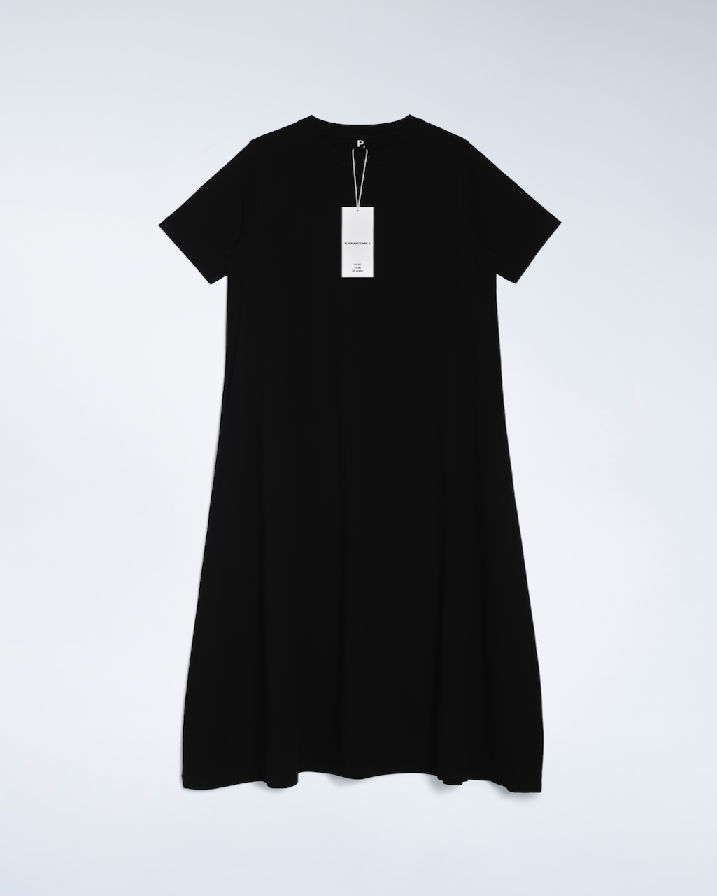 A flatlay of a black, long line, organic cotton t shirt dress.