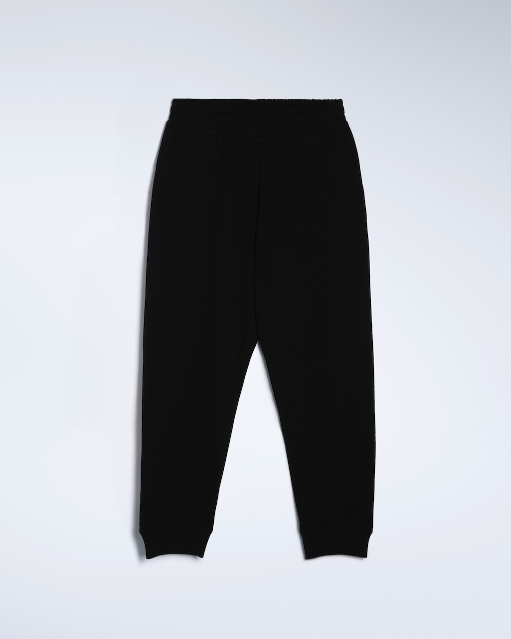 A flatlay of a pair of black, organic cotton joggers.