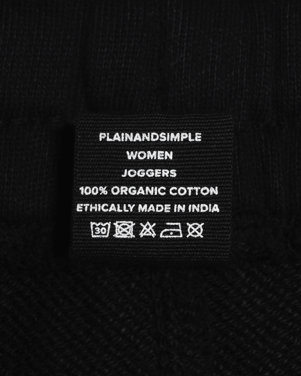 A close up of the label in a pair of black, organic cotton joggers.