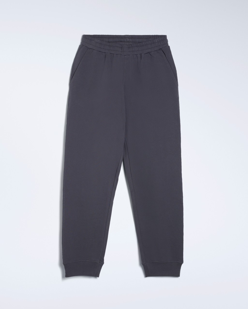 A flatlay of a pair of dark grey, organic cotton joggers.