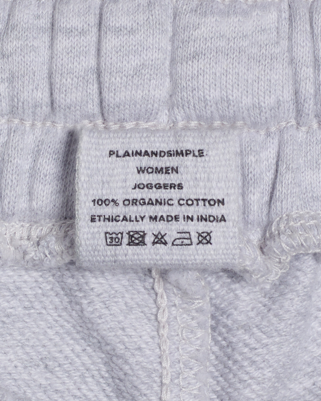 A close up of the label in a pair of grey, organic cotton joggers.