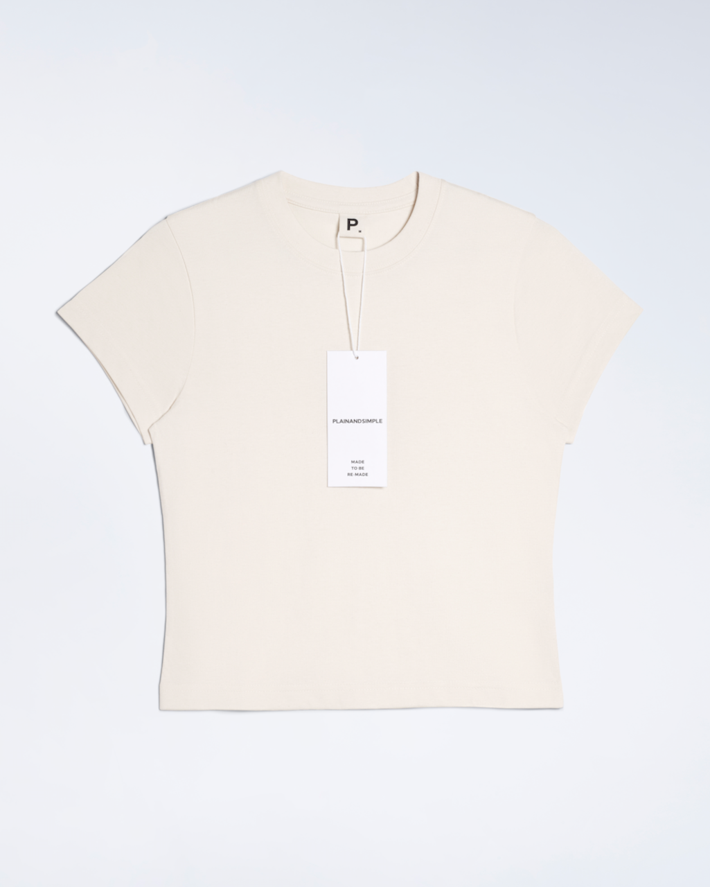 A flatlay of a natural coloured, organic cotton mini t shirt.