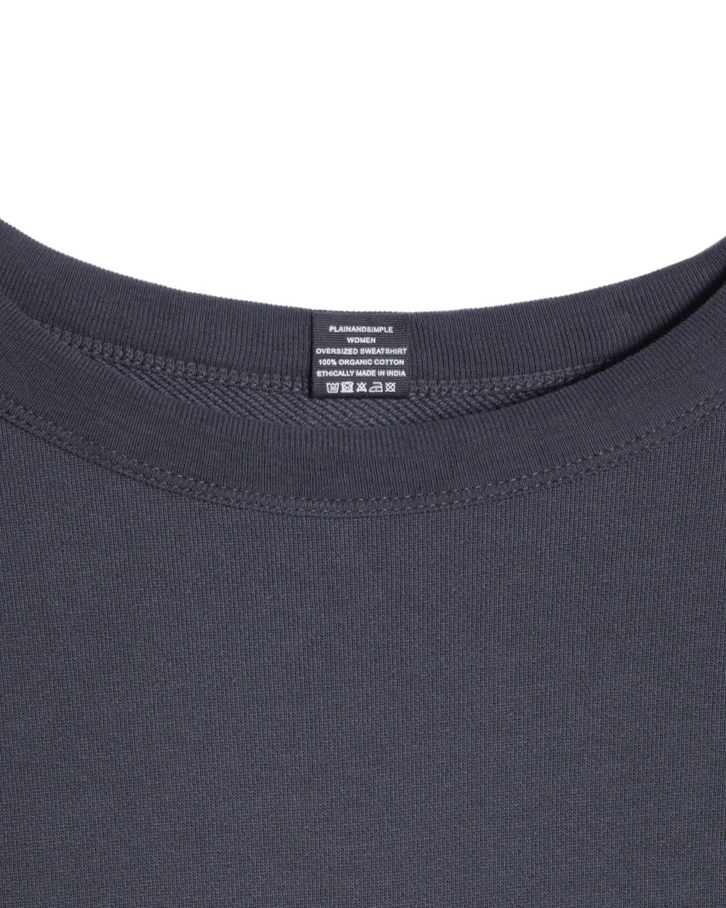 A close up of an neck label in a women's dark grey oversized organic cotton sweatshirt.