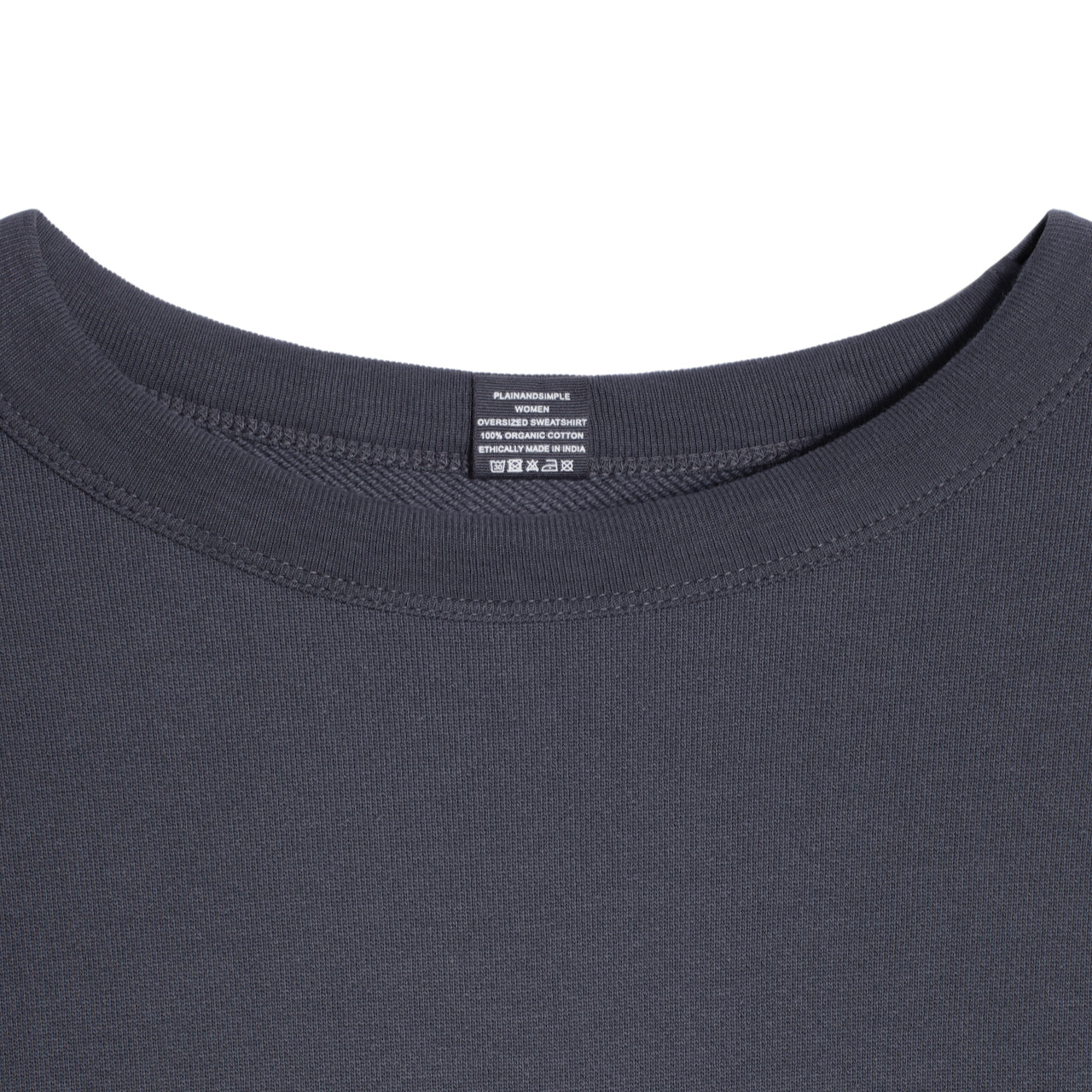 A close up of an neck label in a women's dark grey oversized organic cotton sweatshirt.