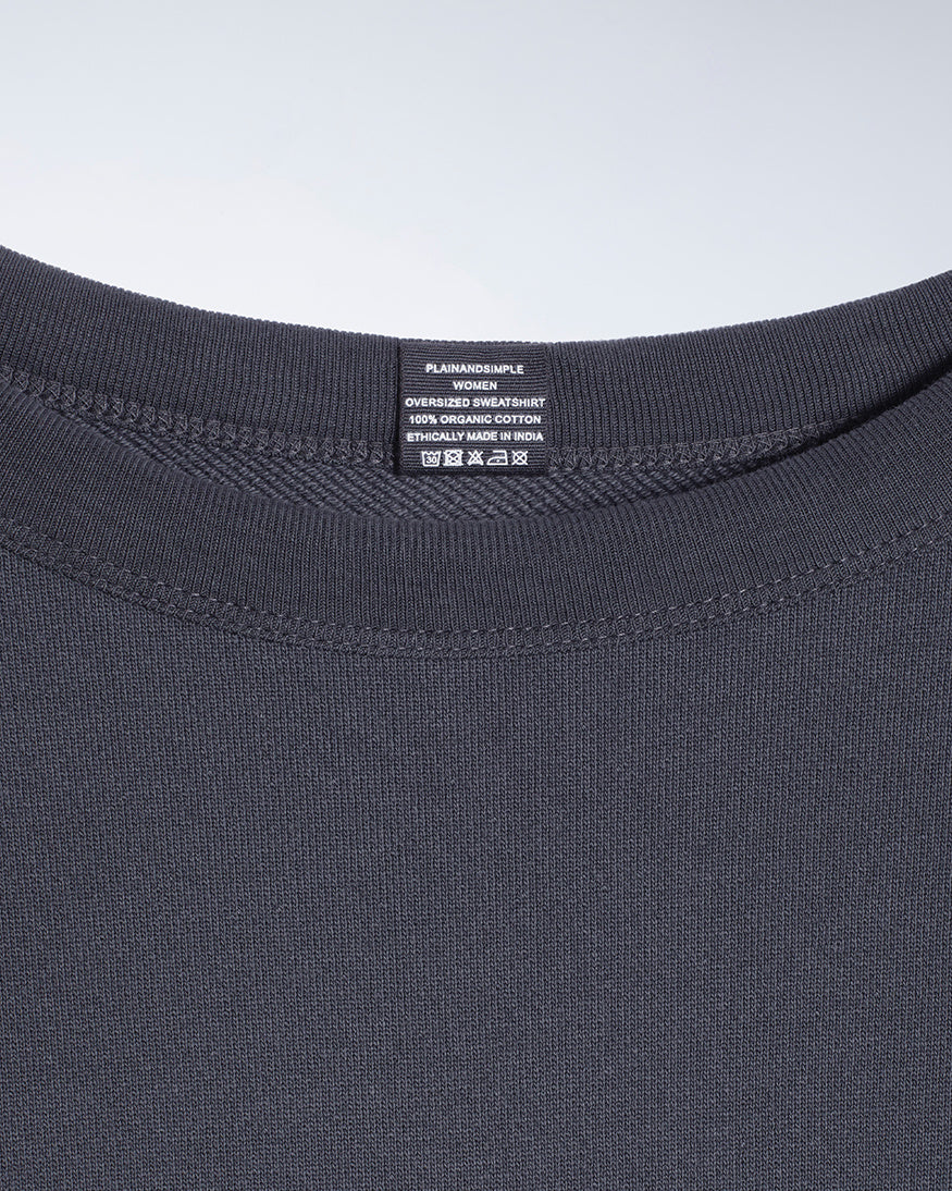 A close up of an neck label in a women's dark grey oversized organic cotton sweatshirt.