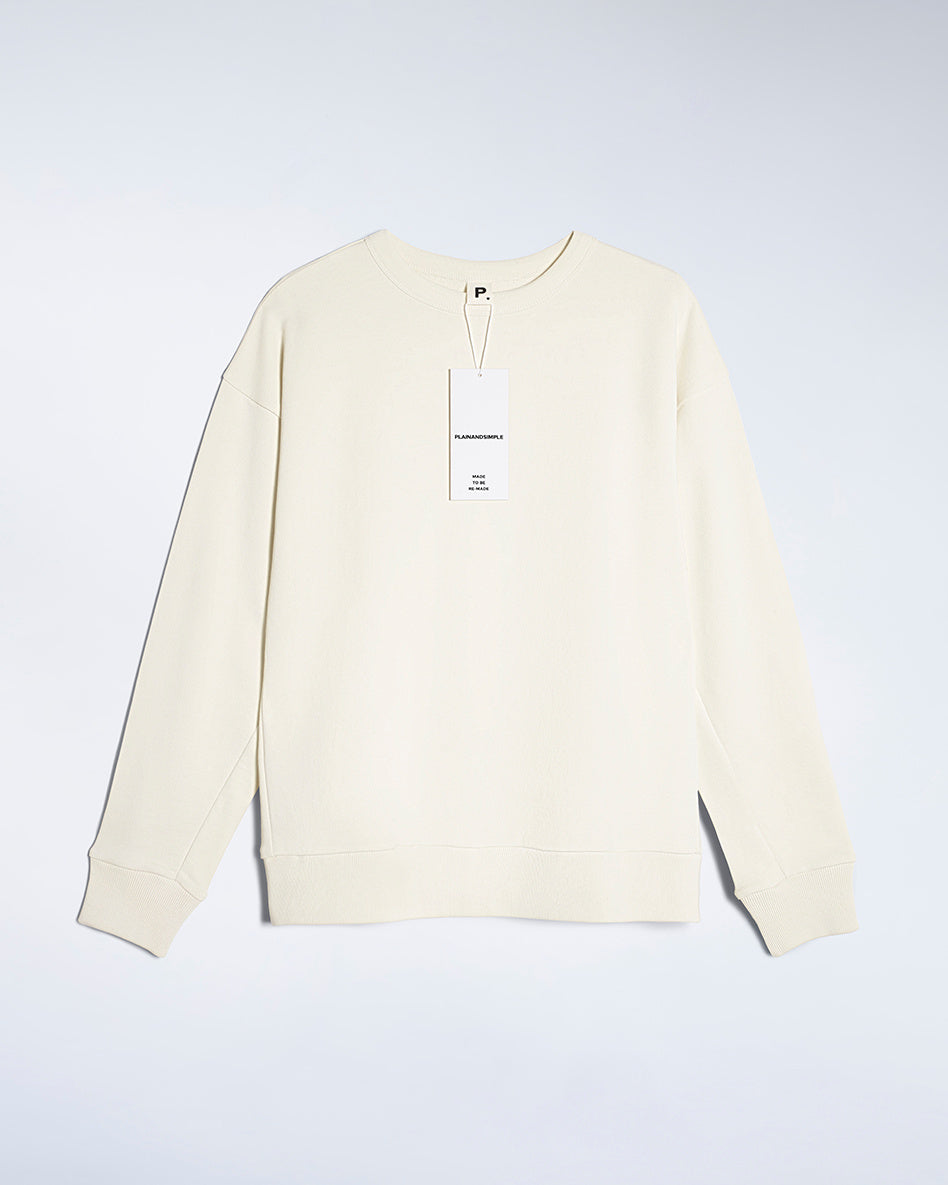 A flatlay of a women's plain ecru oversized organic cotton sweatshirt.