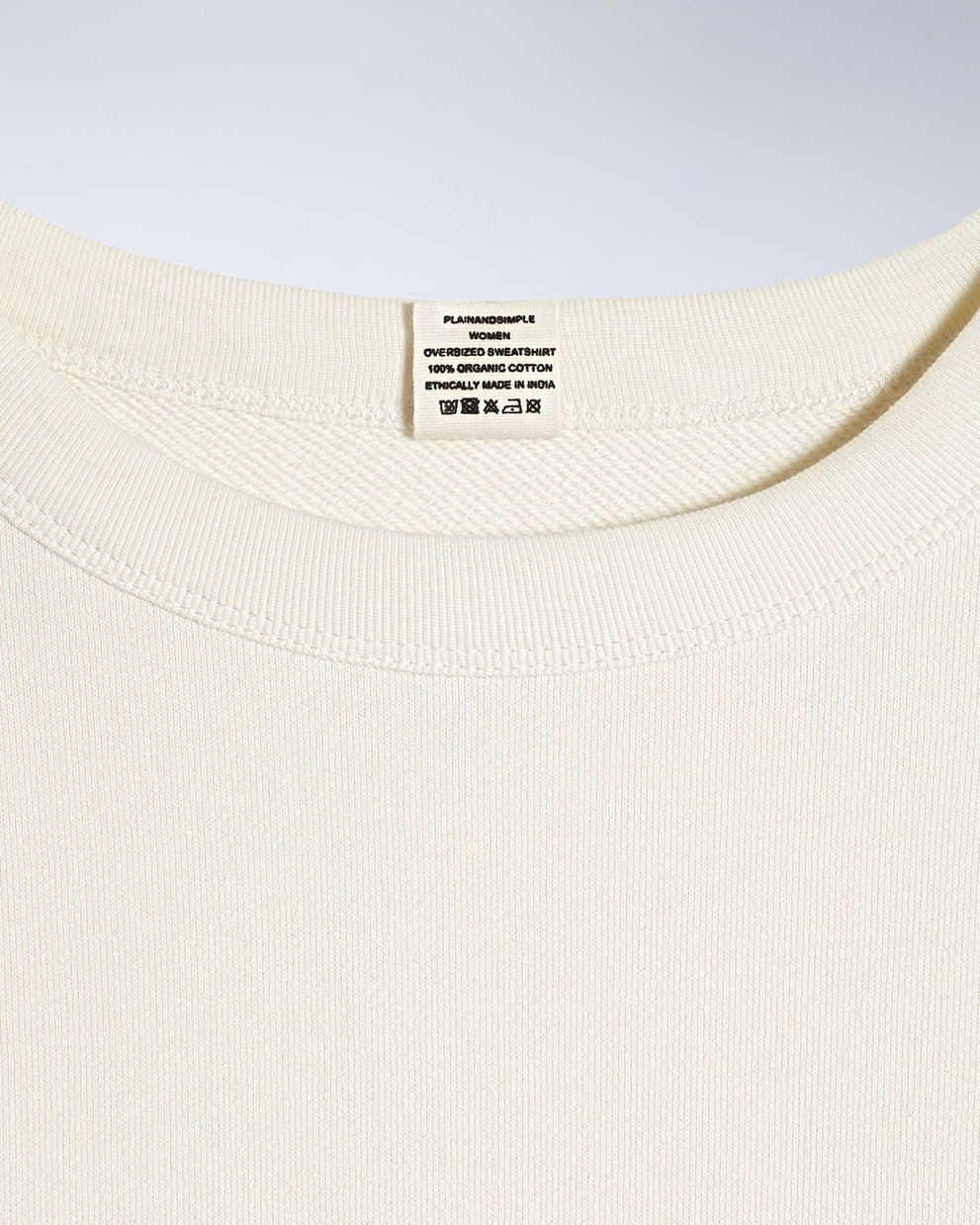 A close up of an neck label in a women's ecru oversized organic cotton sweatshirt.