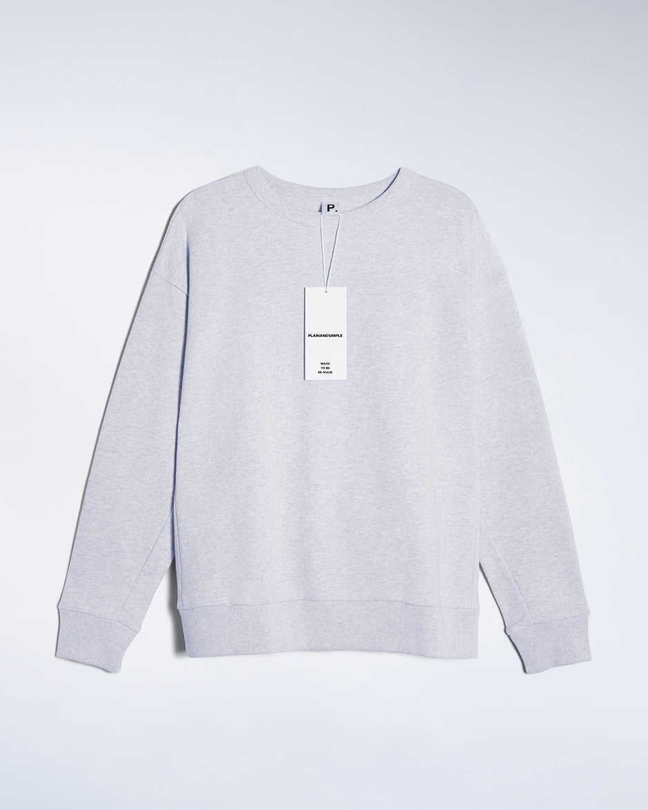 A flatlay of a women's plain grey oversized organic cotton sweatshirt.