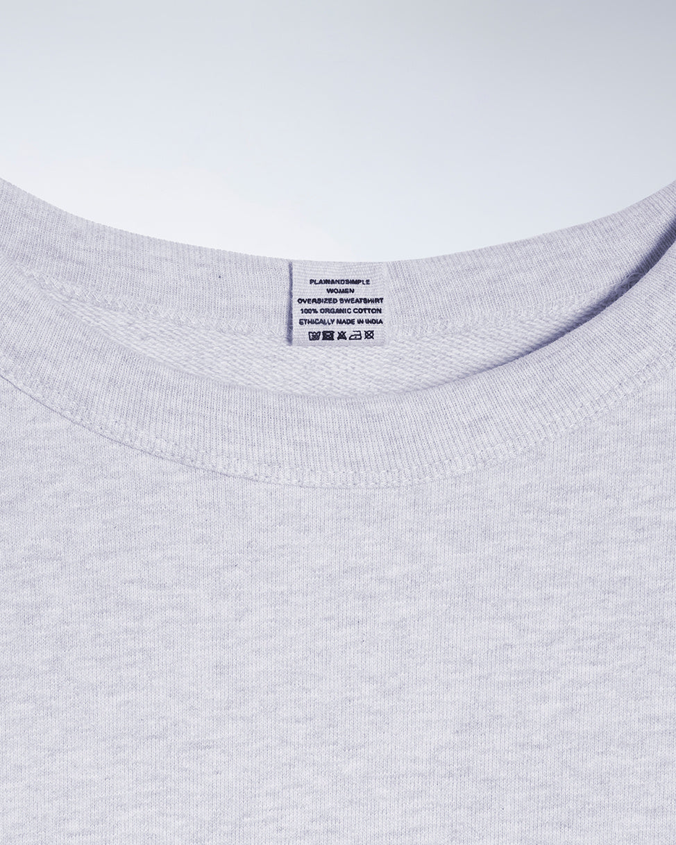 A close up of an neck label in a women's grey oversized organic cotton sweatshirt.