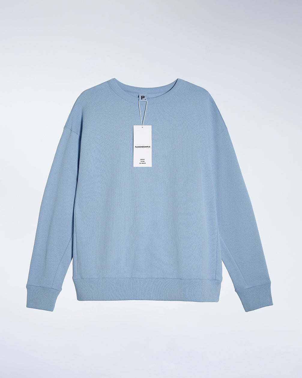 A flatlay of a women's plain blue oversized organic cotton sweatshirt.