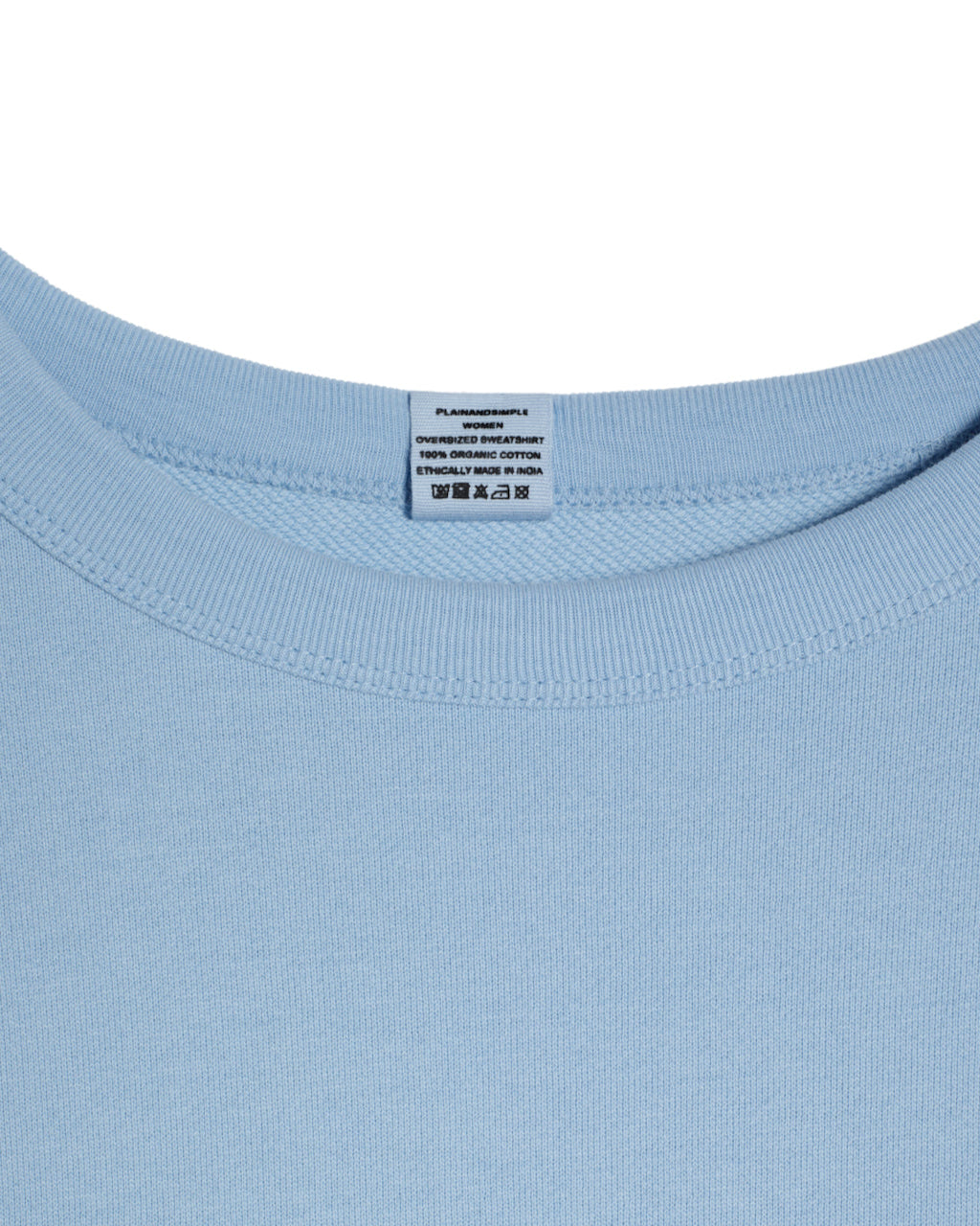 A close up of an neck label in a women's blue oversized organic cotton sweatshirt.