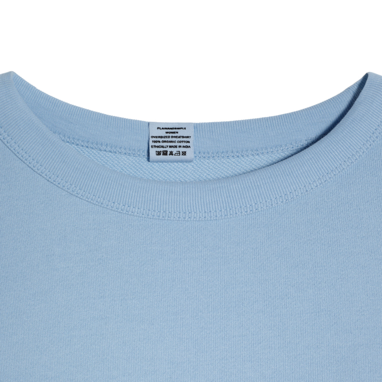 A close up of an neck label in a women's blue oversized organic cotton sweatshirt.
