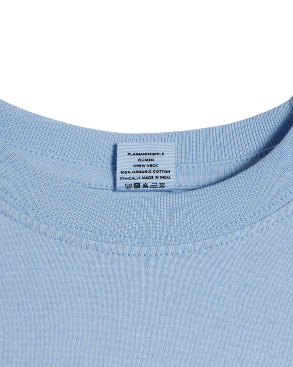 A close up of a neck label in a women's blue short sleeve crew neck organic cotton t shirt.