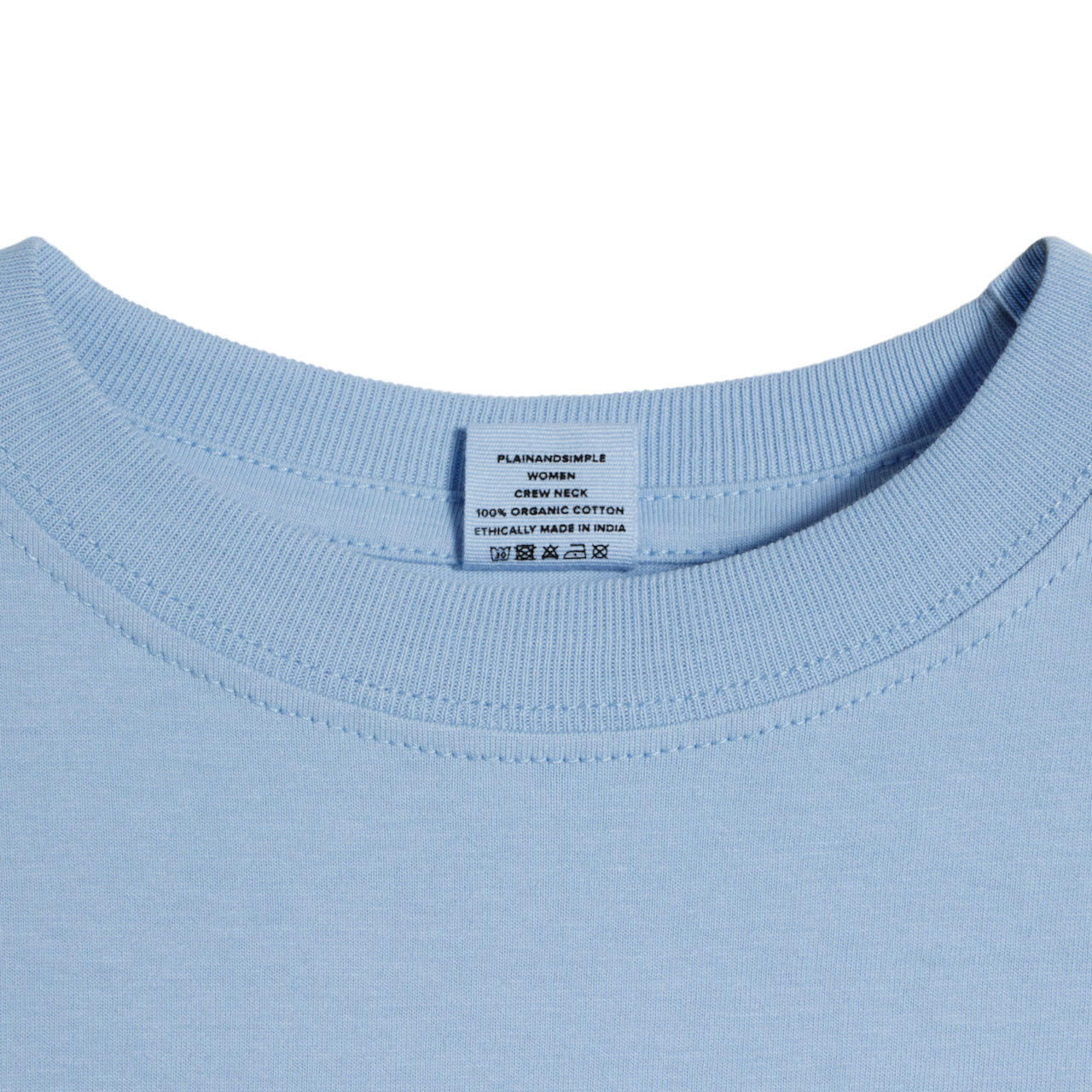 A close up of a neck label in a women's blue short sleeve crew neck organic cotton t shirt.