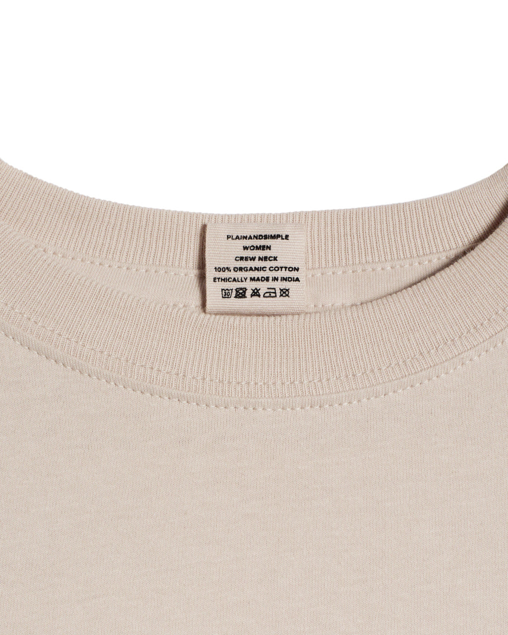 A close up of a neck label in a women's stone short sleeve crew neck organic cotton t shirt.