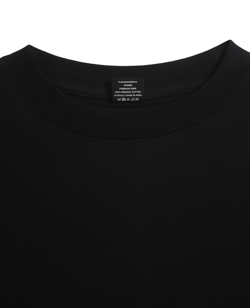 A close up of an neck label in a women's black short sleeve crew neck organic cotton t shirt.