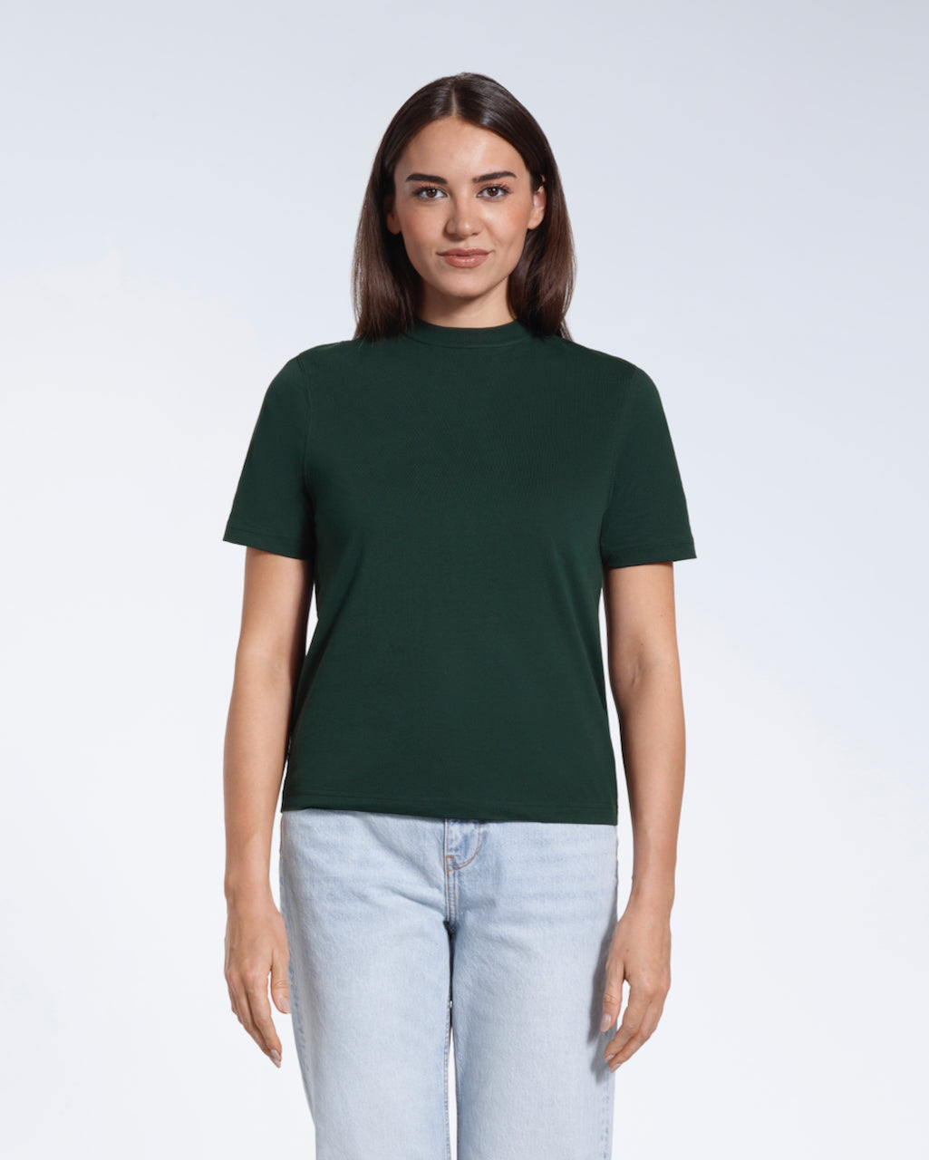 A woman facing front on looking at the camera, modelling a green short sleeve organic cotton t shirt.