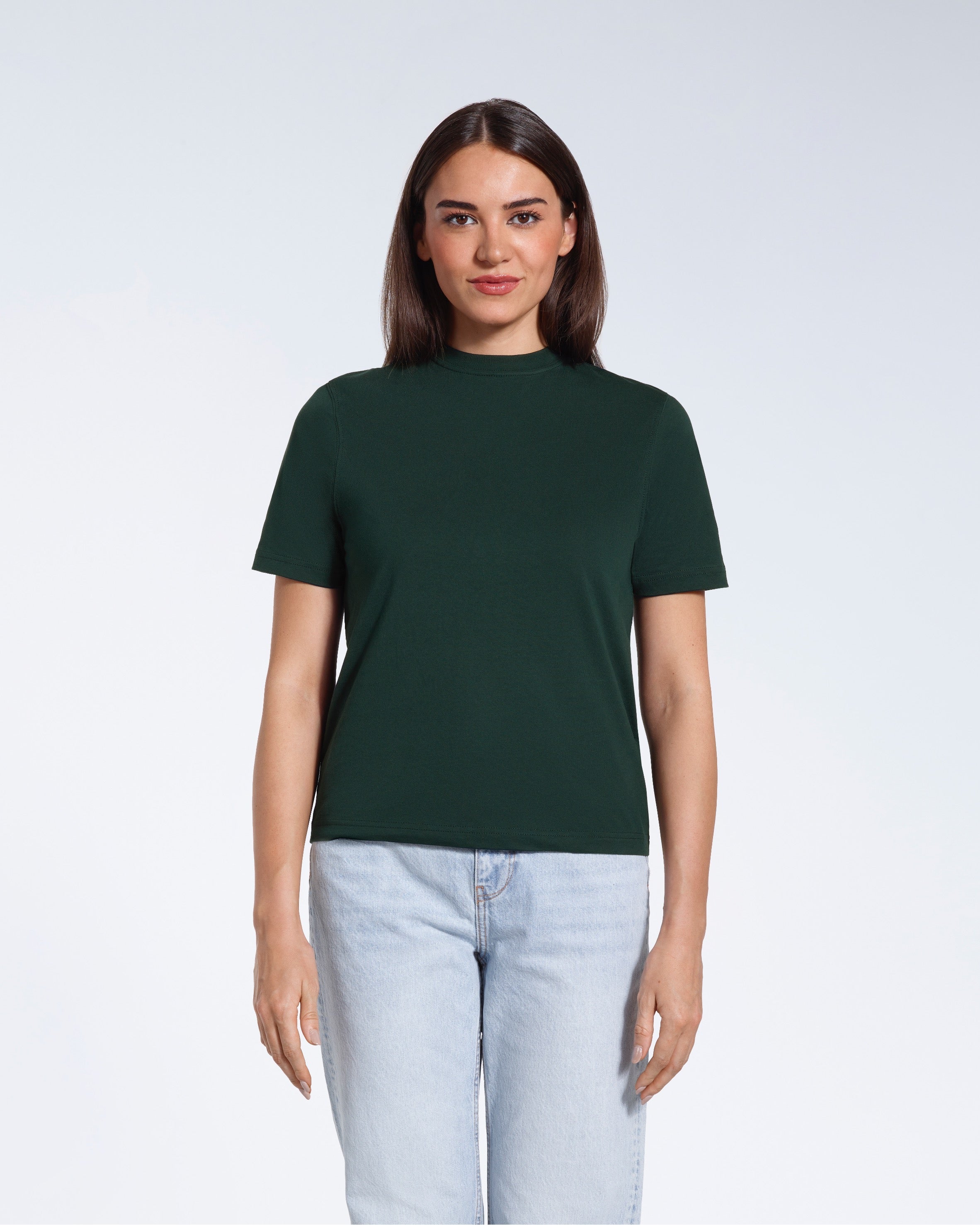 A woman facing front on looking at the camera, modelling a green short sleeve organic cotton t shirt.