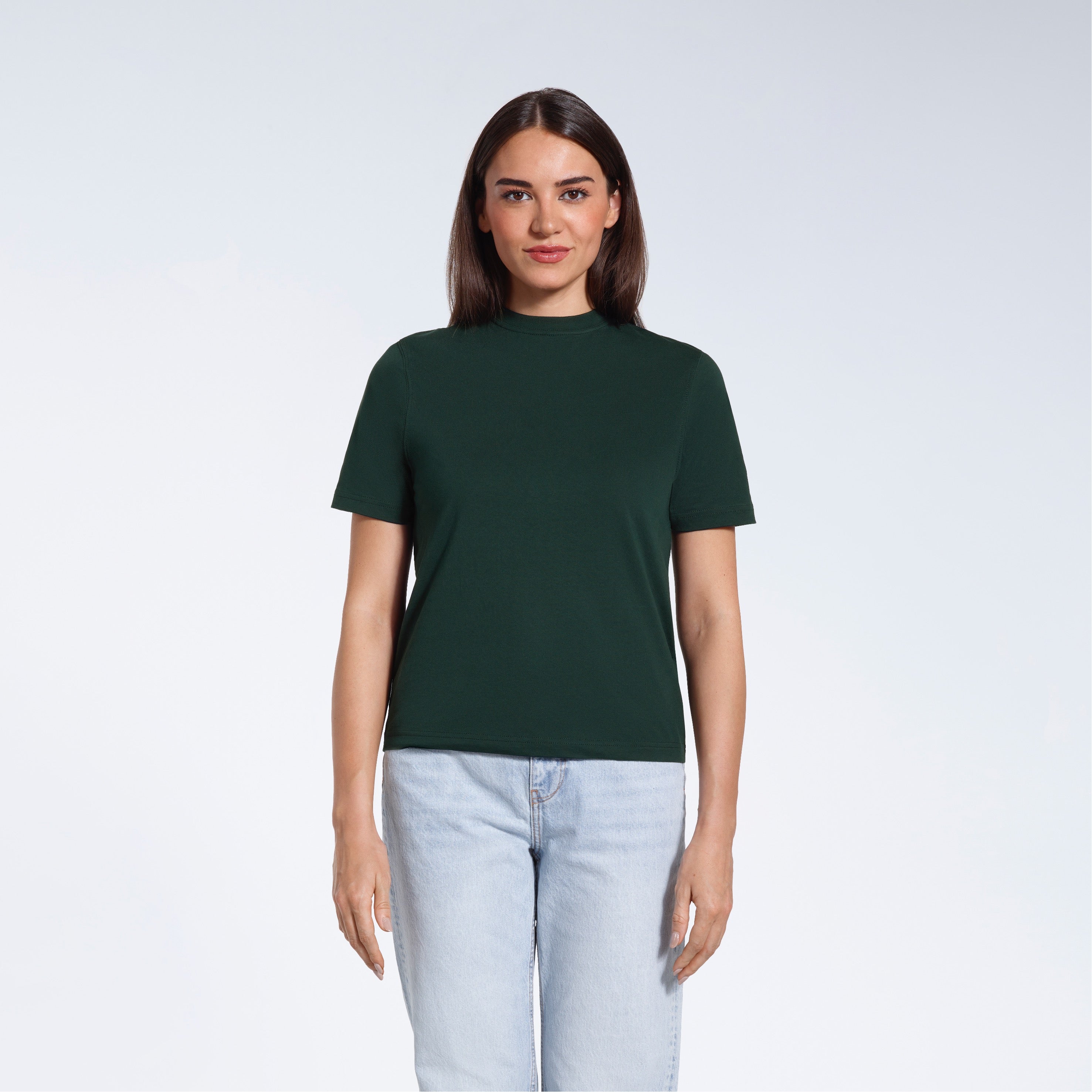 A woman facing front on looking at the camera, modelling a green short sleeve organic cotton t shirt.